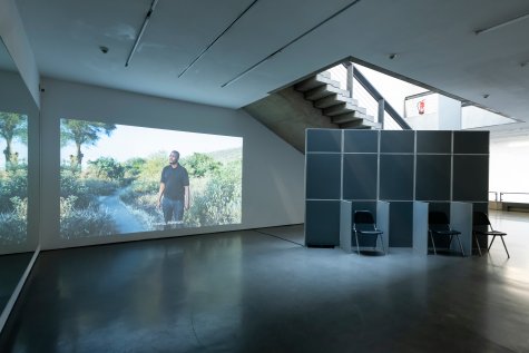 A projector projects an image onto the wall under the staircase in the Kunsthalle.