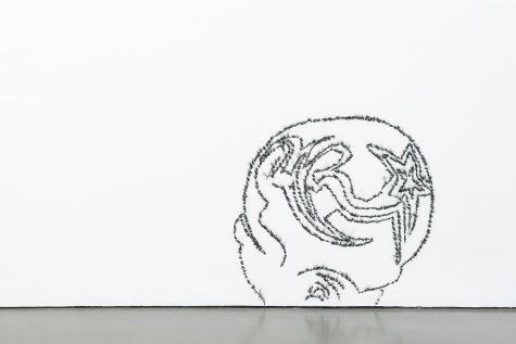 Jeans burned onto the wall with a plumb bob in the outline of the back of a head with a shaved-in hairstyle. 